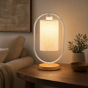 Luminária de mesa oval branca acesa em sala sofisticada