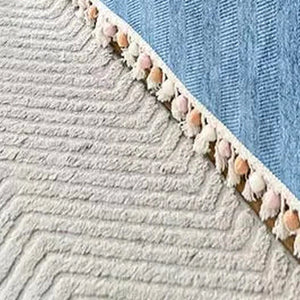 Detalhe do acabamento com pequenas franjas da capa de sofá azul