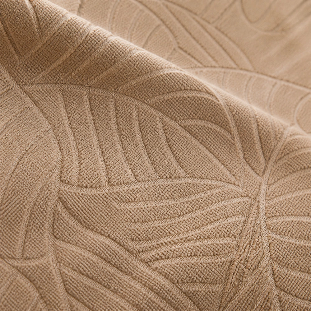 Macro da textura jacquard com padrão de folhas da capa bege