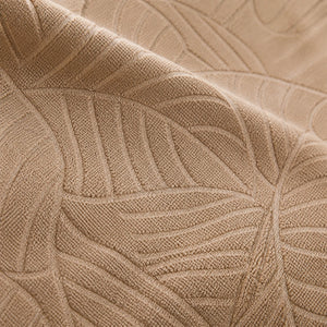 Macro da textura jacquard com padrão de folhas da capa bege